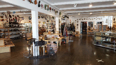 Interior showroom display of Azuca featuring local artwork, gifts, and handcrafted jewelry showcases
